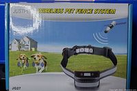 Box front showing Justpet Wireless Pet Fence System branding and usage illustration with two dogs outdoors.