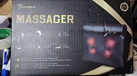 Photo of the Woqqw massager box showing product features and image of the massager with red glowing heated massage nodes.