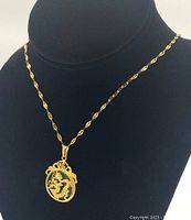 Necklace displayed on black bust showing the pendant and chain design