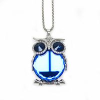 Front-facing photo of blue-stone owl pendant with Cuban chain on white background