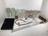 Full lot layout showing all apothecary jars, tubing, timer, box of element samples, and black box likely containing glass slides.