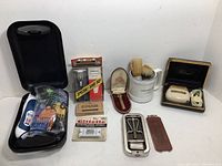 Full overview of lot laid out on white surface including all shaving and grooming items