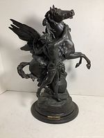 Front-angle view of the full statue showing rearing winged horse and male figure