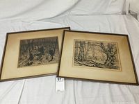 Two framed etchings side by side on a white cloth, showing general appearance and condition including yellowed mats.