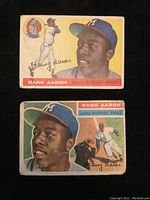 Two 1950s Milwaukee Braves Hank Aaron Topps baseball cards on black backdrop