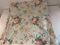 Full view of fabric folded, showing floral pattern.