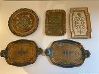 Overview of all five Florentine trays showing shapes, sizes, and painted designs.