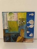 Front view of square abstract painting showing colored blocks and white shapes