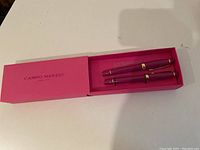 Two unopened mauve purple fountain pens with gold accents in pink Campo Marzio box.