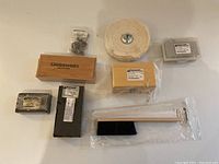 Top view of all Gesswein jewelry making tools including blocks, buffing wheel, brush, and boxes.