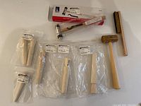 Overview of all ring buffers, mallet hammer, and wire brush laid out on a surface.