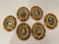 Six gilt wood oval frames arranged in two rows, showing all frame designs and prints