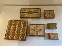 Overview photo showing six vintage Italian Florentine decorative boxes arranged on a white surface, highlighting various sizes and patterns.