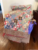 Photo of a multicolor patchwork quilt draped over a chair