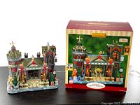 Retired Lemax lighted museum building displayed next to original box showing packaging and design details.