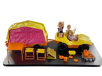 Full view of vintage 1973 Barbie Goin' Camping set with tent trailer, buggy, dolls and camping accessories arranged on black base.