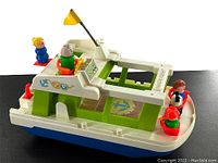 Three-quarter side view of vintage Fisher Price houseboat with five Little People figures placed on and around the boat, showing front and back sides and roof area.