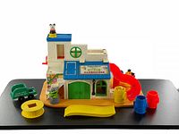 Front view of the vintage Sesame Street Clubhouse playset showing slides, figures, and accessories arranged.