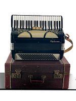 Accordion and original wooden case, front view