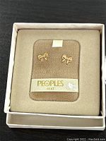 Full lot set: vintage 14K gold People's Jewelers bow stud earrings in original box with storage wear.