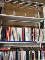 Photo showing a shelf with vintage boxed music albums and vinyl records below.