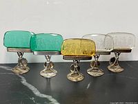 Group view of five place-card holders showing color variation and design