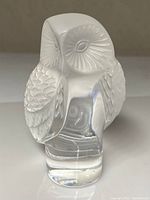 Front close-up view of the frosted crystal owl figurine showing carved eye details and polished clear base.