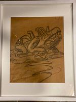 Framed original charcoal drawing showing stylized Northwest Coast animals and faces with distinct indigenous art features.