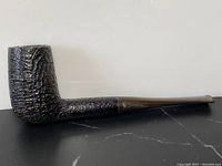 Side view of antique burl pipe showing textured bowl and smooth brown stem with Georg Jensen signature.