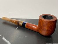 Side view of the antique Duncan Hill Aerosphere burl pipe, showing polished wooden bowl and shank with blue and brass band, and pearlescent mouthpiece.