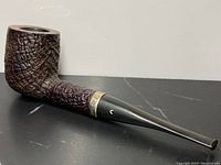 Full side view of antique burl wood pipe with black mouthpiece and sterling silver band, signed by Comoy's