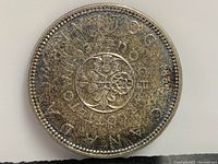 Reverse side of 1964 Canadian Silver Dollar showing floral emblem and year 1964 with inscriptions.