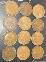 Top side showing the obverse of the British pennies with monarchs' heads