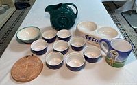 Overview of most ceramic items including pitcher, bowls, divided dish, mug, and trivet