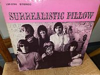 Front cover of Surrealistic Pillow vinyl album by Jefferson Airplane with pink background and band photo