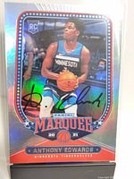 Front image of holographic Anthony Edwards rookie card showing autograph and player in Minnesota Timberwolves jersey.