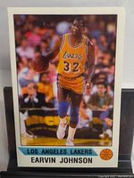 Mini sticker card of Earvin Magic Johnson in Lakers uniform with basketball, on court action shot.
