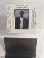 Full camera slide showing Kobe Bryant wearing black leather jacket and white shirt with event details printed on frame