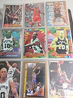 Collection of framed basketball cards featuring Dennis Rodman in Chicago Bulls and Spurs uniforms plus others from assorted brands