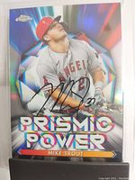 Front of card showing Mike Trout batting in Angels uniform with chrome prismatic foil background and autograph.
