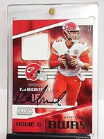 Front of card in magnetic holder showing autograph and jersey patch