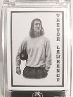 Front of the card showing black and white image of Trevor Lawrence with his name printed vertically on right side.