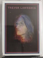 Front view of Trevor Lawrence 2021 Topps rookie card showing artistic side portrait with dark background and red name text.
