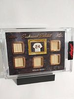 Front of Willie Mays memorabilia card showing six fabric swatches and jersey number 24 design, numbered 3/20, encased in acrylic.