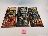 Top-down photo of all 10 Boris Karloff Tales of Mystery comic books laid out in two rows, showing colorful covers with classic mid-century horror artwork.