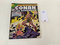 Front cover of the comic showing Conan The Barbarian in a dramatic pose with fiery background.