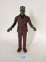 Full front view of the Frankenstein's Monster action figure standing upright, showing overall size and condition.