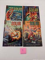Four Dr. Solar comics laid flat, showing front covers in a 2x2 arrangement