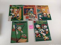 Five Walt Disney's Comics and Stories comic books laid out showing colorful covers featuring Donald Duck and family.