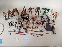 Full lot overview showing a large number of various action figures and accessories spread on a surface, including humanoid characters, creatures, and weapons.